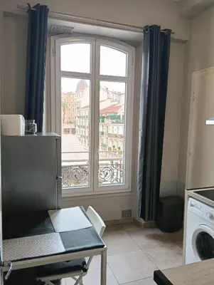 a kitchen with a window with a view of a city at Studio central Nice in Nice