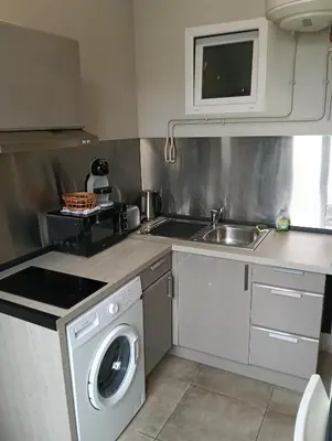 a kitchen with a washing machine and a sink at Studio central Nice in Nice