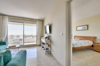 a living room with a couch and a bed and a bedroom at T3 avec terrasse vue sur mer à 400m de la plage in Nice