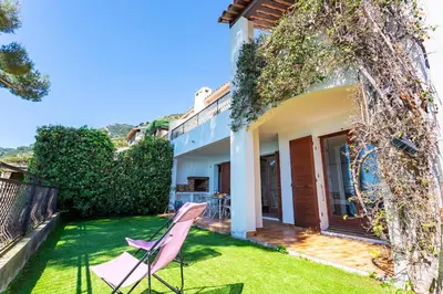 a yard with a pink chair and a house at LA SOLEILLADE VI4451 By Riviera Holiday Homes in Èze