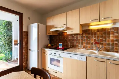 a kitchen with a white refrigerator and a sink at LA SOLEILLADE VI4451 By Riviera Holiday Homes in Èze