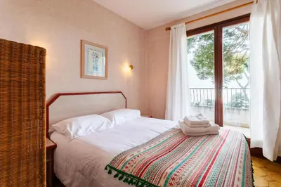 a bedroom with a bed and a large window at LA SOLEILLADE VI4451 By Riviera Holiday Homes in Èze