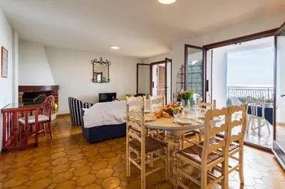 a dining room with a table and a room with a bed at LA SOLEILLADE VI4451 By Riviera Holiday Homes in Èze