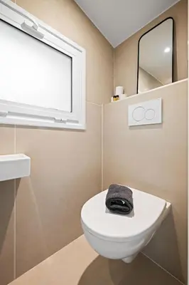 a bathroom with a white toilet and a window at Vieux Nice - Dernier étage climatisé in Nice