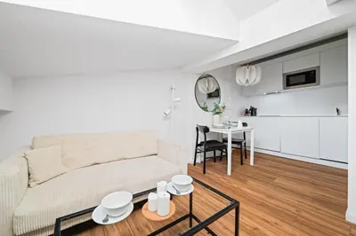 a living room with a couch and a table at Vieux Nice - Dernier étage climatisé in Nice