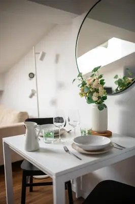 a white table with wine glasses and a mirror at Vieux Nice - Dernier étage climatisé in Nice