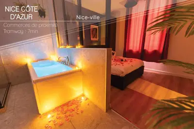 a bathroom with a sink and a bed with a tub at Nice Centre - Loft - Balnéo 1 in Nice
