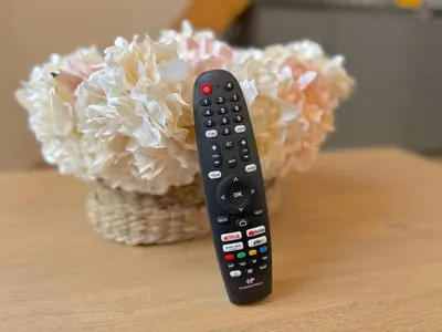 a remote control sitting on a table next to a flower at ⁂ Appartement élégant et central à Nice in Nice