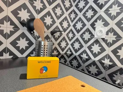 a yellow box and utensils on a counter at ⁂ Appartement élégant et central à Nice in Nice