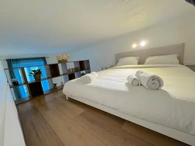 a bedroom with a large white bed with towels on it at ⁂ Appartement élégant et central à Nice in Nice