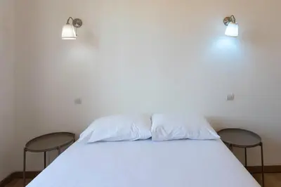 a white bed with two chairs in a room at #37 1BDR Bagatelle, Promenade, sea front Balcony & AC in Nice
