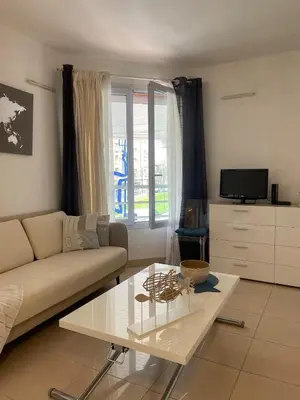 a living room with a couch and a coffee table at Perfect Studio Nice Beach Airport in Nice