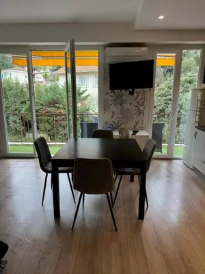 a dining room with a black table and chairs at Spacious Riviera Studio in Nice
