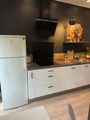 a kitchen with white cabinets and a white refrigerator at Spacious Riviera Studio in Nice