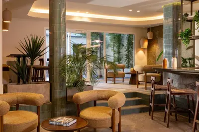 a lobby of a restaurant with chairs and tables at Ikonik Marengo in Nice
