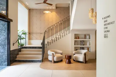 a lobby with two chairs and a staircase at Ikonik Marengo in Nice