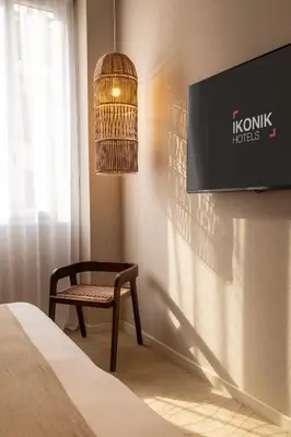 a restaurant with tables and chairs and a bar at Ikonik Marengo in Nice