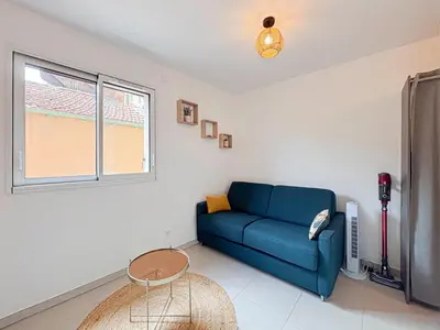 a living room with a tv and a table and a window at Confort & Élégance - Wifi, 2 pers in Nice