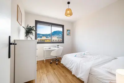 a white bedroom with a bed and a desk at MY CASA - DELFINO - Charming roof terrace apartment w AC in Nice