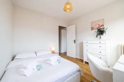 a white bedroom with a bed and a dresser at MY CASA - DELFINO - Charming roof terrace apartment w AC in Nice