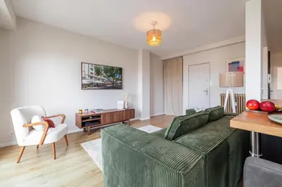 a living room with a green couch and a table at MY CASA - DELFINO - Charming roof terrace apartment w AC in Nice