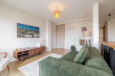 a living room with a green couch and a table at MY CASA - DELFINO - Charming roof terrace apartment w AC in Nice