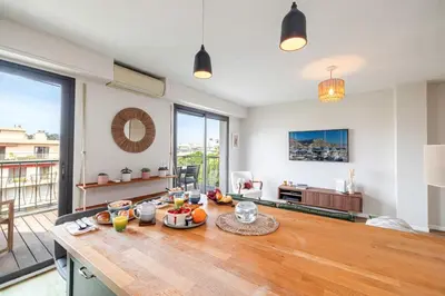 a living room with a table with food on it at MY CASA - DELFINO - Charming roof terrace apartment w AC in Nice