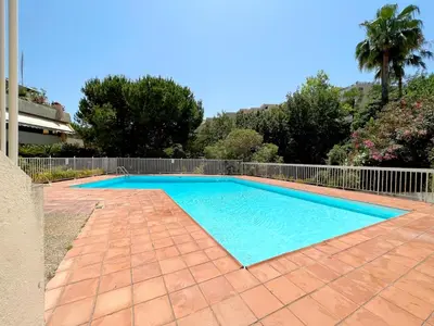 a swimming pool in a yard with a fence at La Pastourelle Studio Close to Sea Pool Parking in Nice