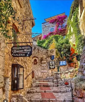 a stone building with a sign on the side of it at Appartement entre Monaco et Nice Calme et tout équipé in Èze