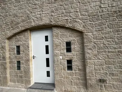 a stone building with a white door in it at Villa La Mer new apartment 75 m2 very quiet in Cagnes-sur-Mer