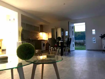 a living room with a table and a kitchen at Villa La Mer new apartment 75 m2 very quiet in Cagnes-sur-Mer