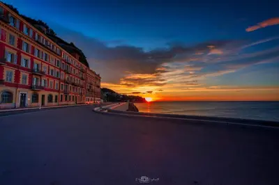 an empty street with a sunset on the ocean at Villa La Mer new apartment 75 m2 very quiet in Cagnes-sur-Mer