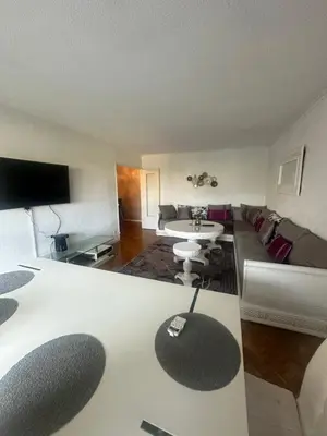 a living room with a couch and a table at Apartment near Beach-Airport Open 24h in Saint-Laurent-du-Var