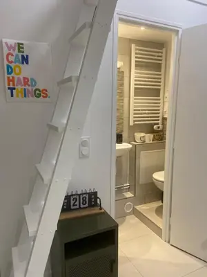 a white bathroom with a staircase and a toilet at Studio Garibaldi in Nice