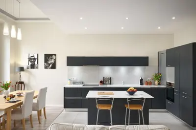 a kitchen with a island with a table and chairs at Sunlight Properties - Gisele - Nice hyper central, 1 bedroom with large living room in Nice