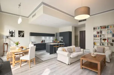a living room with a couch and a table at Sunlight Properties - Gisele - Nice hyper central, 1 bedroom with large living room in Nice