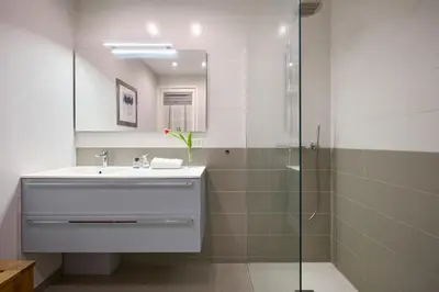 a bathroom with a sink and a shower at Sunlight Properties - Gisele - Nice hyper central, 1 bedroom with large living room in Nice