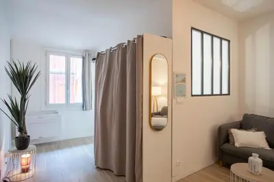 a living room with a mirror and a couch at #16 1BDR Flower market, Old Town, 1min beach AC in Nice