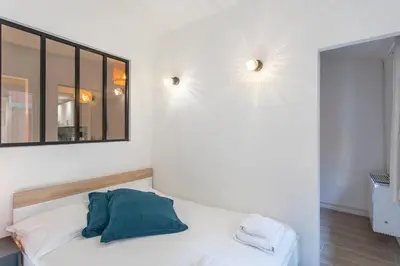 a room with a bed with a mirror on the wall at #16 1BDR Flower market, Old Town, 1min beach AC in Nice