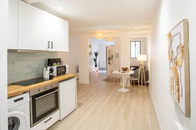 a kitchen with white cabinets and a dining room at #16 1BDR Flower market, Old Town, 1min beach AC in Nice