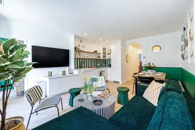 a living room with a couch and a tv at NEW! Remodeled & Spacious 4 Bedroom - 3 Bath - Heart of Nice - AC in all rooms - With a large elevator in Nice