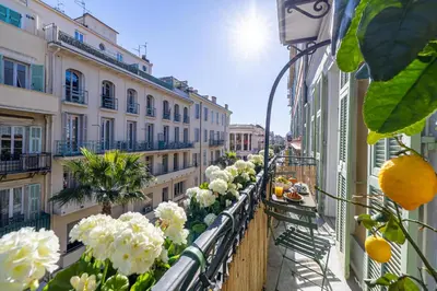 a balcony with white flowers on a building at NEW! Remodeled & Spacious 4 Bedroom - 3 Bath - Heart of Nice - AC in all rooms - With a large elevator in Nice