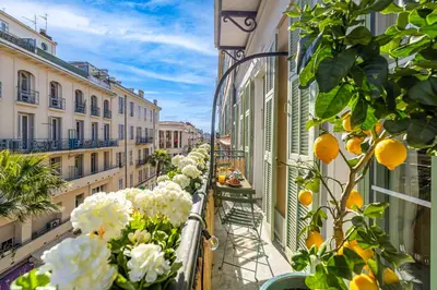an apartment balcony with flowers on the balconies at NEW! Remodeled & Spacious 4 Bedroom - 3 Bath - Heart of Nice - AC in all rooms - With a large elevator in Nice