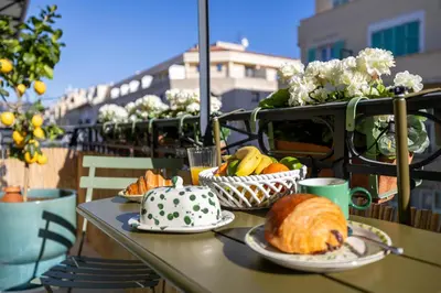 a table with plates of food on a balcony at NEW! Remodeled & Spacious 4 Bedroom - 3 Bath - Heart of Nice - AC in all rooms - With a large elevator in Nice