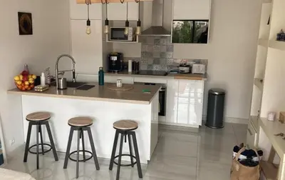 a kitchen with two bar stools and a counter top at 2P cosy à Nice in Nice