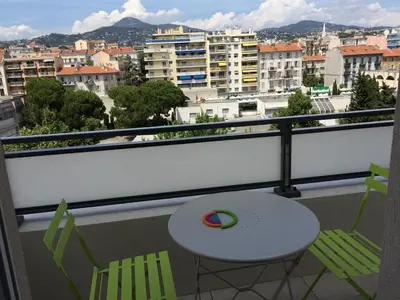 a balcony with a table and chairs and a view of a city at Ma place au sud Nice 604 in Nice