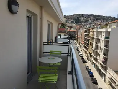 a balcony with a table and chairs on a balcony at Ma place au sud Nice 604 in Nice