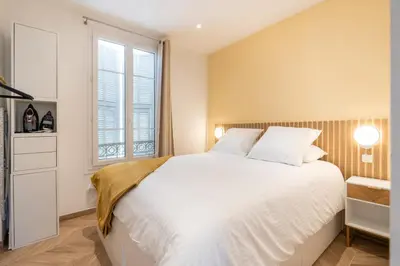 a bedroom with a large white bed and a window at Design Apartment near the Beaches of Nice in Nice