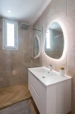a bathroom with a white sink and a mirror at Design Apartment near the Beaches of Nice in Nice