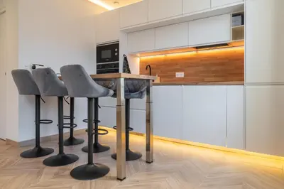 a kitchen with two bar stools and a counter at Design Apartment near the Beaches of Nice in Nice